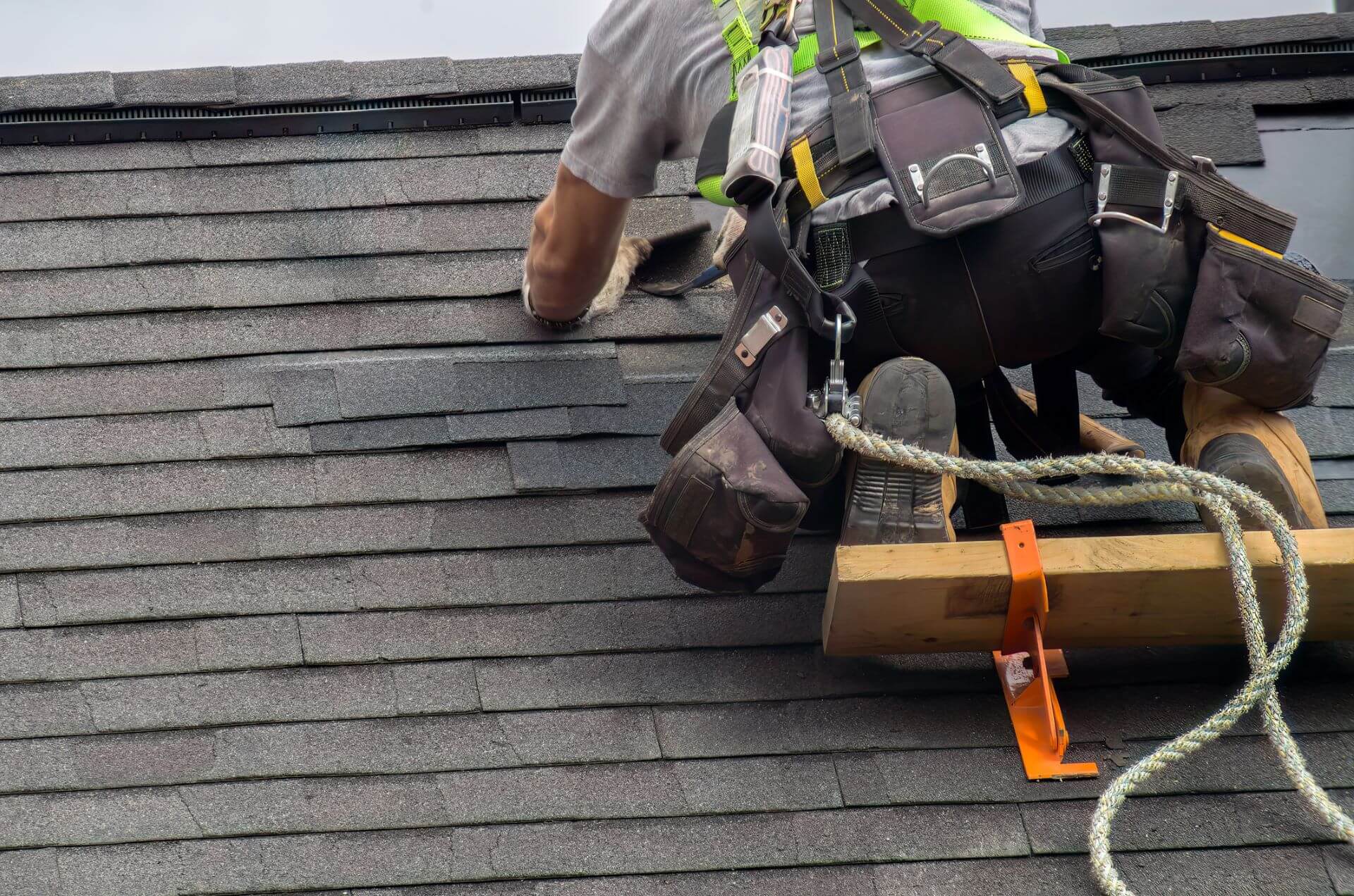 Residential Roof Replacement Louisiana - An image of a HUDCO Roof Tech installing a roof.